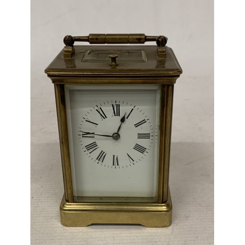 30 - A FRENCH BRASS CARRIAGE CLOCK WITH GLASS ESCAPEMENT (ONE PANE MISSING)