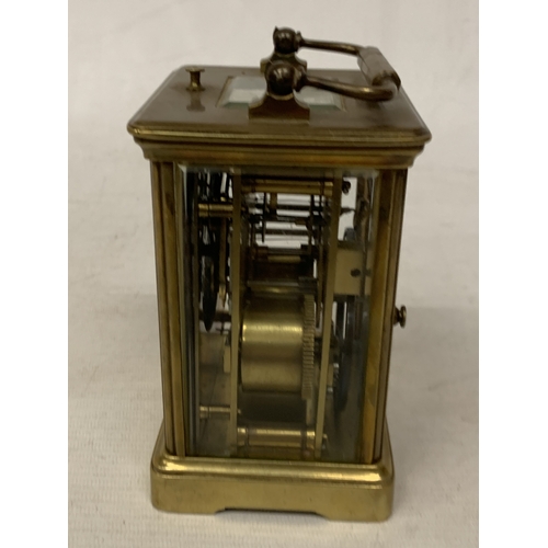 30 - A FRENCH BRASS CARRIAGE CLOCK WITH GLASS ESCAPEMENT (ONE PANE MISSING)