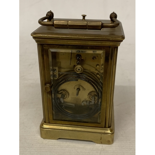 30 - A FRENCH BRASS CARRIAGE CLOCK WITH GLASS ESCAPEMENT (ONE PANE MISSING)