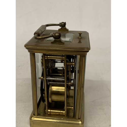 30 - A FRENCH BRASS CARRIAGE CLOCK WITH GLASS ESCAPEMENT (ONE PANE MISSING)