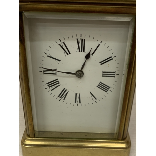 30 - A FRENCH BRASS CARRIAGE CLOCK WITH GLASS ESCAPEMENT (ONE PANE MISSING)