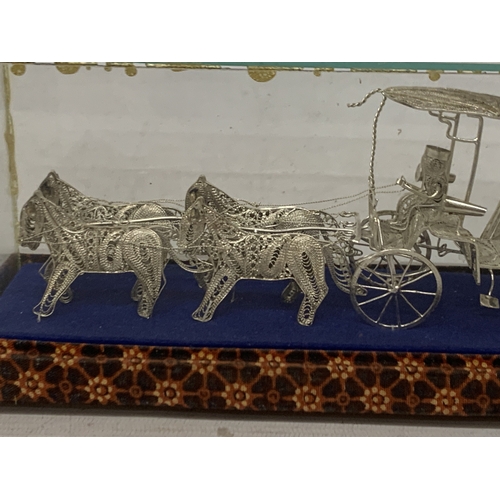 7 - A SILVER WIRE MODEL OF A CARRIAGE AND HORSES IN A GLASS CASE