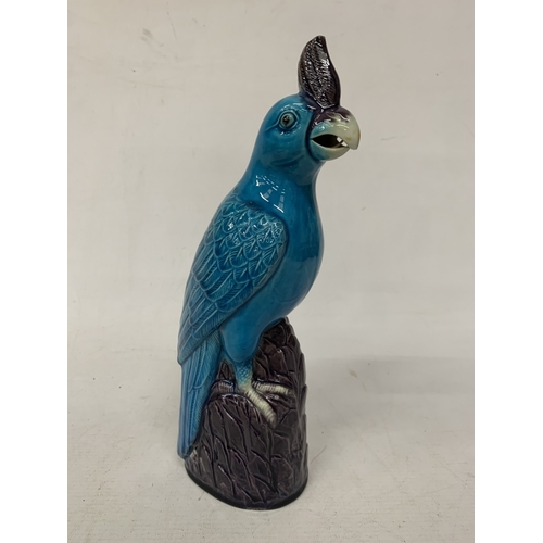 42 - A VINTAGE CHINESE PORCELAIN PARROT FIGURE, WITH A TURQUOISE GLAZED BODY AND AUBERGINE COLOURED CREST... 