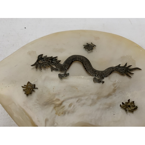 50 - A CHINESE EXPORT SILVER DRAGON RELIEF DISH, MOUNTED ON A MOTHER OF PEARL SHELL, 18CM X 14CM