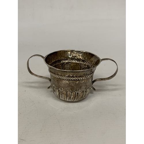 30A - A SILVER TWIN HANDLED CUP WITH REPOUSSE DECORATION - WEIGHT 59.34 G