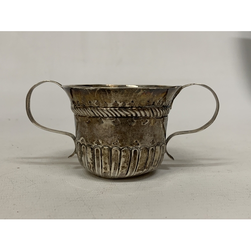 30A - A SILVER TWIN HANDLED CUP WITH REPOUSSE DECORATION - WEIGHT 59.34 G