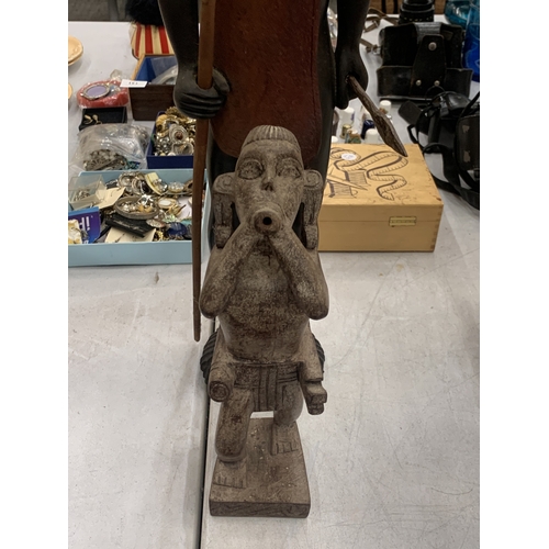 112 - A LARGE TRIBAL FIGURE HOLDING A SPEAR TOGETHER WITH A FURTHER SMALLER TRIBAL FIGURE
