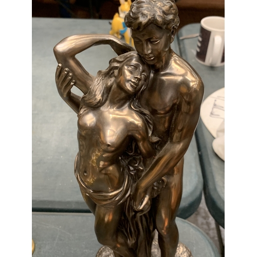 153 - A GILT RESIN STATUE OF TWO NAKED LOVERS