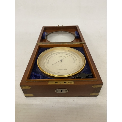 16 - AN ANEROID DESK BAROMETER MANUFACTURED BY STANLEY OF LONDON WITH A CIRCULAR GLAZED WINDOW ON A HINGE... 