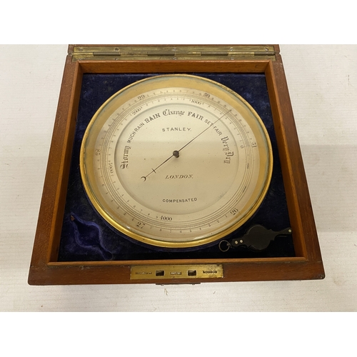16 - AN ANEROID DESK BAROMETER MANUFACTURED BY STANLEY OF LONDON WITH A CIRCULAR GLAZED WINDOW ON A HINGE... 