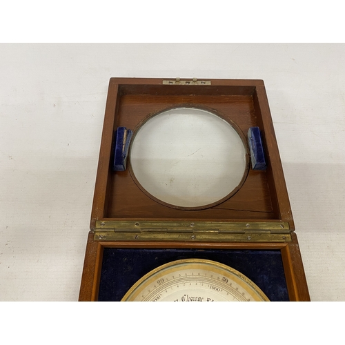 16 - AN ANEROID DESK BAROMETER MANUFACTURED BY STANLEY OF LONDON WITH A CIRCULAR GLAZED WINDOW ON A HINGE... 