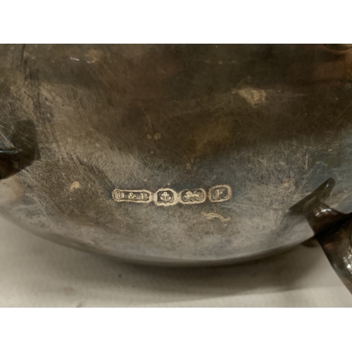 1 - A 1930'S HALLMARKED BIRMINGHAM SILVER SAUCE BOAT WITH A WAVY EDGE RIM AND RAISED ON THREE ORNATE FEE... 