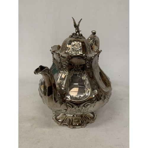 37 - A ROCOCO STYLE SILVER PLATE TEAPOT WITH HIGH RELIEF DECORATION WITH AN EAGLE FINIAL