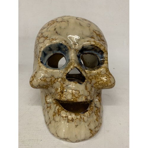 53 - A CERAMIC BROWN AND BEIGE DRIP GLAZE SKULL CANDLE HOLDER