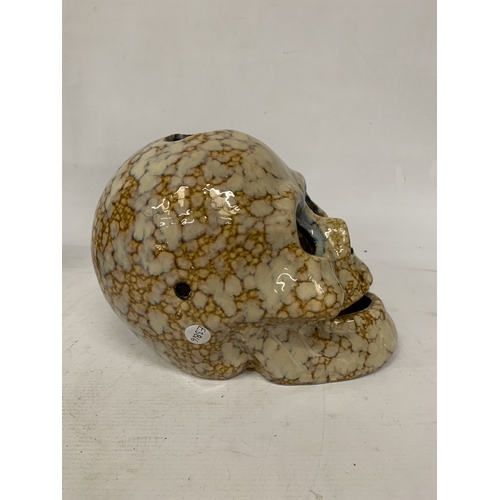 53 - A CERAMIC BROWN AND BEIGE DRIP GLAZE SKULL CANDLE HOLDER