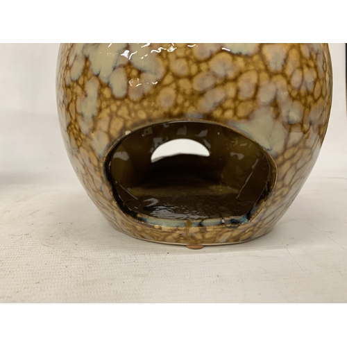 53 - A CERAMIC BROWN AND BEIGE DRIP GLAZE SKULL CANDLE HOLDER