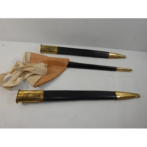 331 - A COLLECTION OF THREE BRASS AND LEATHER SCABBARDS, ONE FOR A SOCKET BAYONET, LENGTHS 45CM