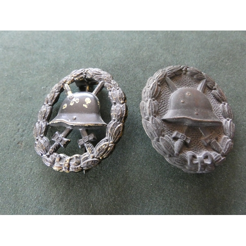 355 - A WORLD WAR I IMPERIAL GERMAN PIERCED BLACK PAINTED WOUND BADGE AND A SIMILAR SOLID BACK EXAMPLE (2)