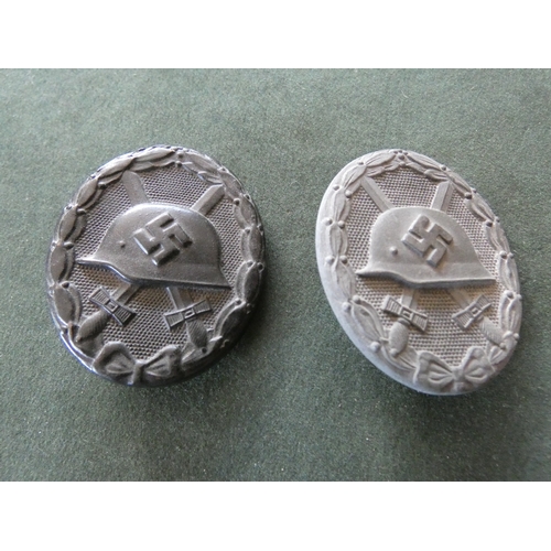 356 - A WORLD WAR II NAZI GERMANY GREY METAL WOUND BADGE AND A BLACK PAINTED VERSION (2)