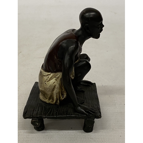 13 - A BRONZE COLD PAINTED FIGURE OF A SQUATTING MAN, HEIGHT 11 CM