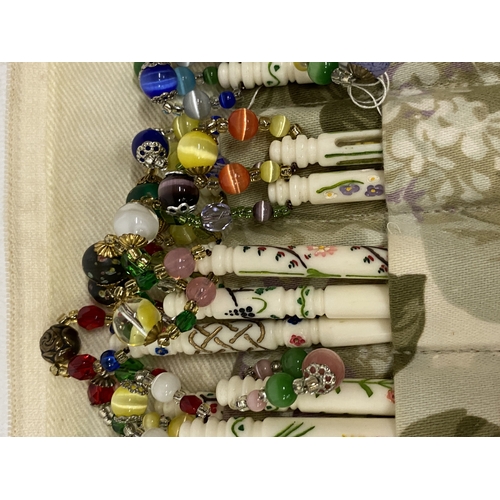 32 - A COLLECTION OF APPROX 54 BONE LACE MAKING BOBBINS WITH DECORATION, CHARMS AND SPANGLES