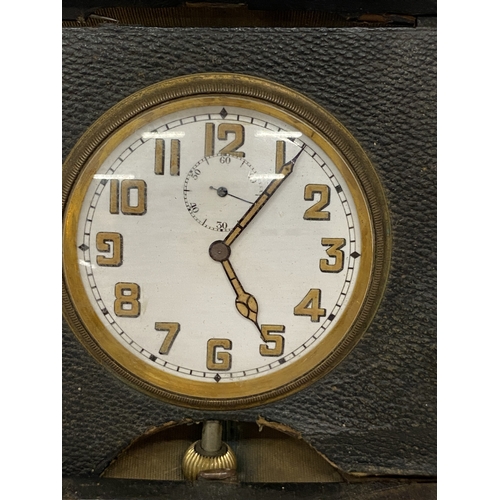 35 - A VINTAGE FOLDING LEATHER-CASED BELIEVED TO BE SWISS MADE 8 DAY  MOVEMENT MEDHANICAL TRAVEL CLOCK