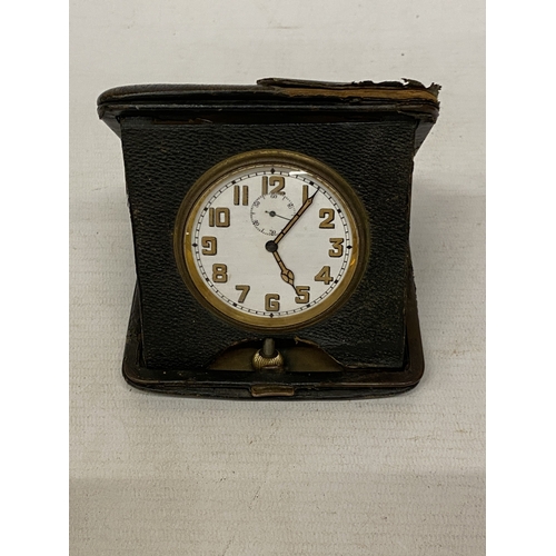 35 - A VINTAGE FOLDING LEATHER-CASED BELIEVED TO BE SWISS MADE 8 DAY  MOVEMENT MEDHANICAL TRAVEL CLOCK