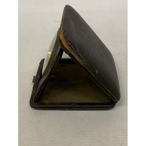 35 - A VINTAGE FOLDING LEATHER-CASED BELIEVED TO BE SWISS MADE 8 DAY  MOVEMENT MEDHANICAL TRAVEL CLOCK