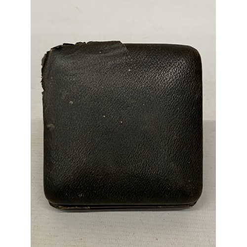 35 - A VINTAGE FOLDING LEATHER-CASED BELIEVED TO BE SWISS MADE 8 DAY  MOVEMENT MEDHANICAL TRAVEL CLOCK