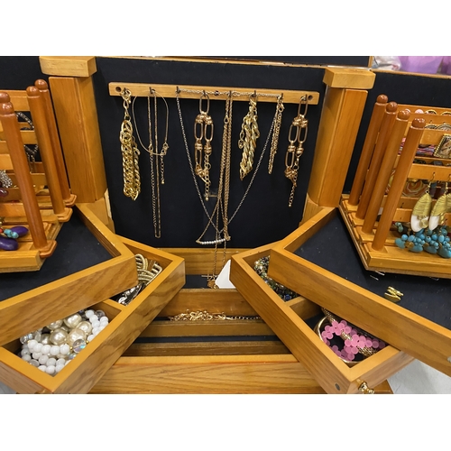33 - A LARGE PINE JEWELLERY BOX WITH VARIOUS COMPARTMENTS AND MIRROR CONTAING A QUANTITY OF COSTUME JEWEL... 