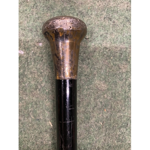 50 - A VINTAGE WALKING CANE WITH A DARK EBONIZED WOODEN SHAFT AND HALLMARKED BIRMINGHAM SILVER HANDLE