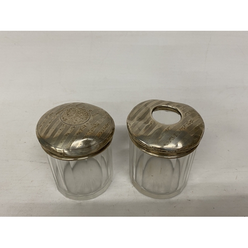 52 - TWO GLASS AND HALLMARKED BIRMINGHAM SILVER DRESSING TABLE JARS