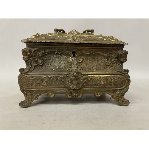 11 - A GILDED CASKET WITH REPOUSSE FLORAL AND SCROLL DECORATION WITH CHERUB ACCENTS IN THE CORNERS WITH K... 