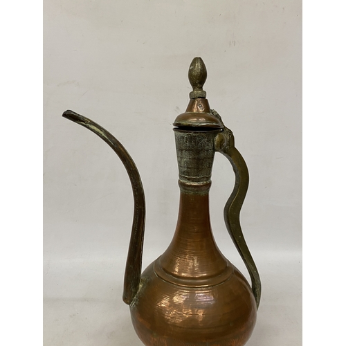 65 - A MIDDLE EASTERN HAMMERED COPPER EWER
