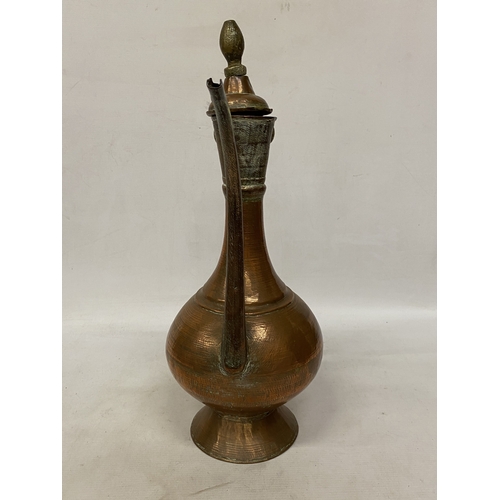 65 - A MIDDLE EASTERN HAMMERED COPPER EWER
