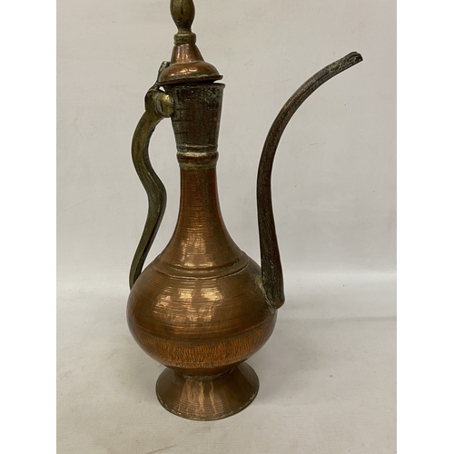 65 - A MIDDLE EASTERN HAMMERED COPPER EWER