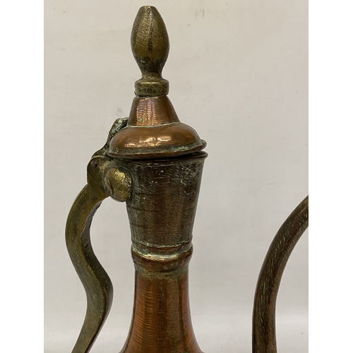 65 - A MIDDLE EASTERN HAMMERED COPPER EWER