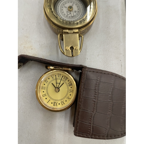 115 - A BRASS COMPASS AND A SMALL CASED CLOCK
