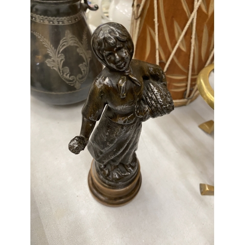 179 - A SPELTER FIGURE OF A LADY WITH A BASKET, HEIGHT 25CM