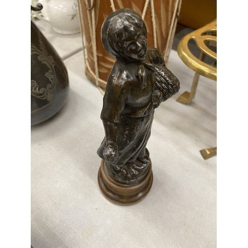 179 - A SPELTER FIGURE OF A LADY WITH A BASKET, HEIGHT 25CM