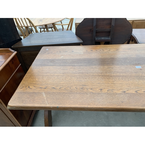 AN OAK REFECTORY TABLE ON X FRAME BASE 70