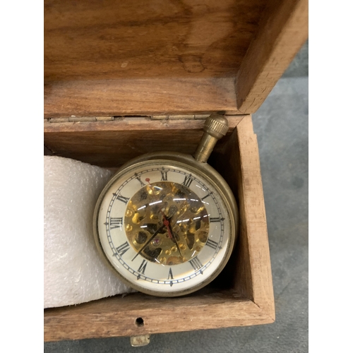 A BUBBLE CLOCK HOUSED IN A WOODEN BOX