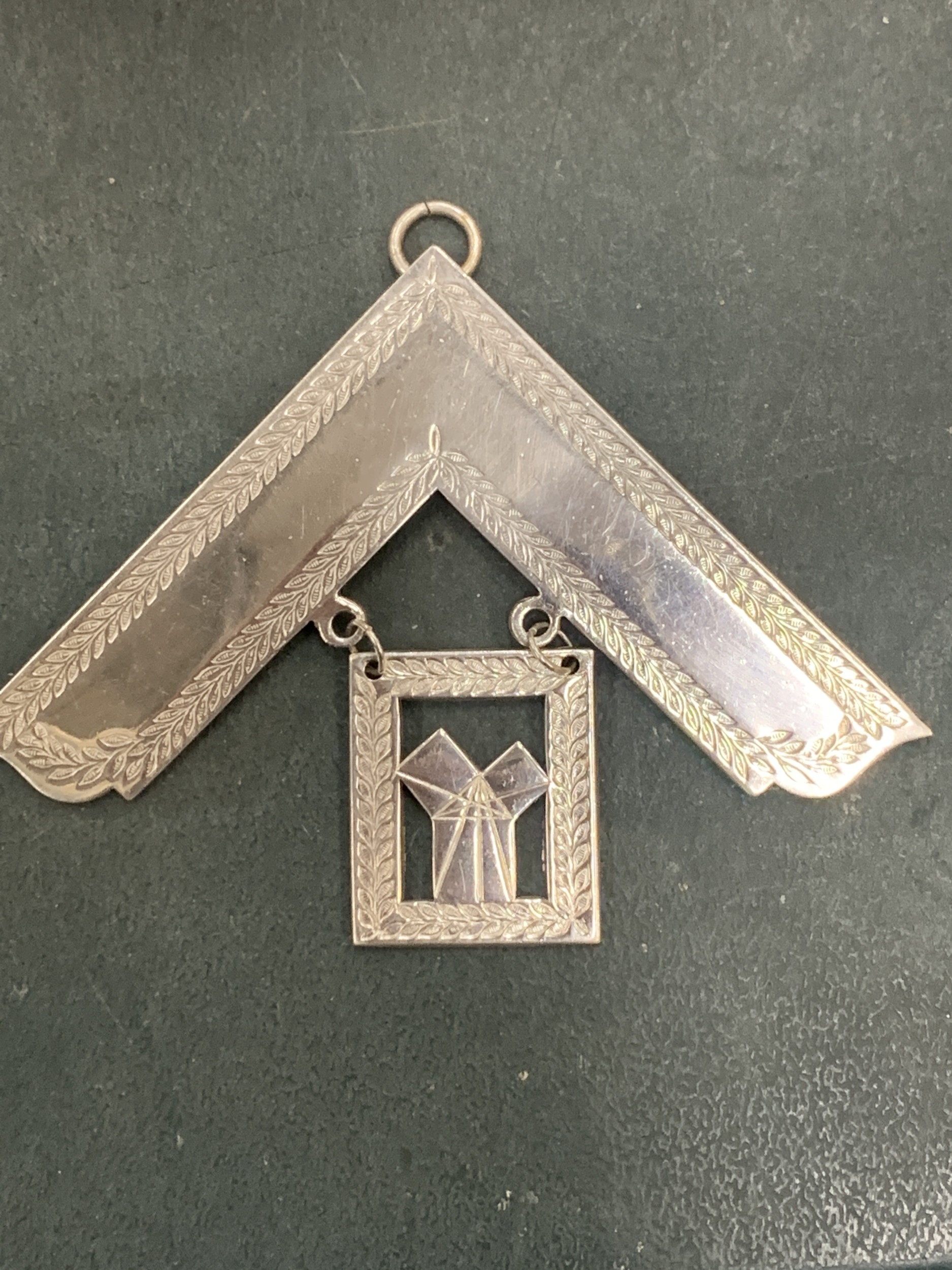 A SILVER PLATED MASONIC BADGE