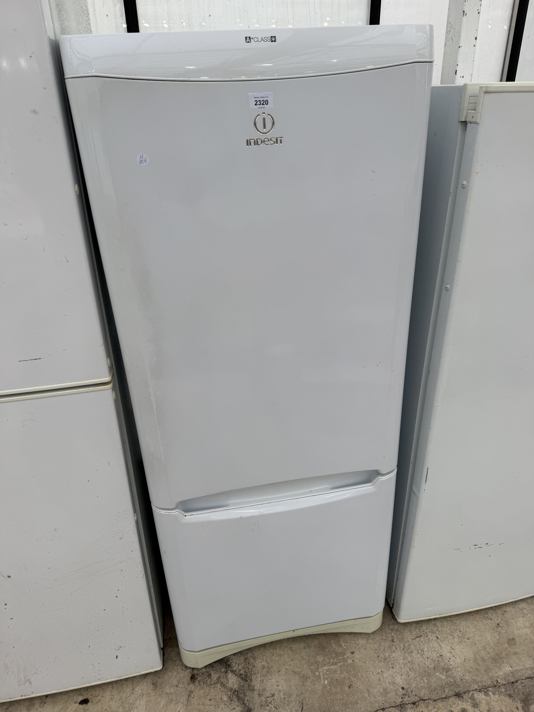 A WHITE INDESIT UPRIGHT FRIDGE FREEZER