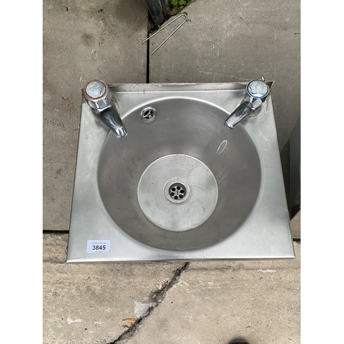 A SMALL STAINLESS STEEL HAND SINK WITH HOT AND COLD TAPS - NO VAT