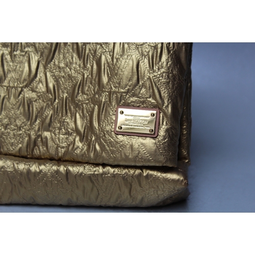 A LOUIS VUITTON QUILTED POUCH GOLD LIMELIGHT CLUTCH BAG, with