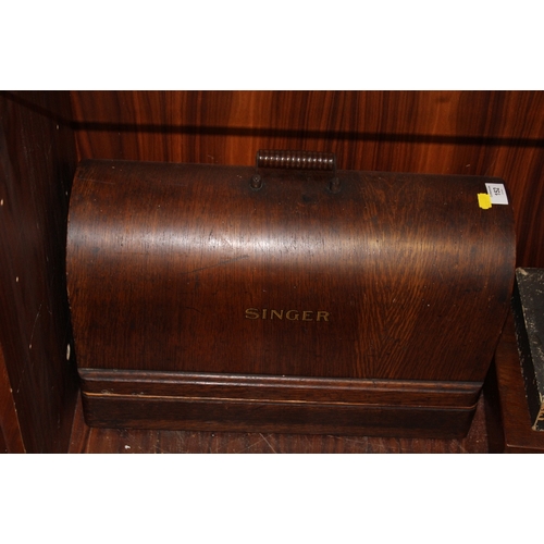 152 - A VINTAGE OAK CASED SINGER SEWING MACHINE