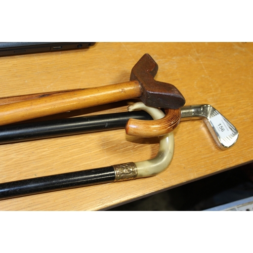 156 - FIVE ASSORTED WALKING STICKS TO INCLUDE A YELLOW METAL BANDED EXAMPLE, MODERN GOLF INTEREST EXAMPLE ... 