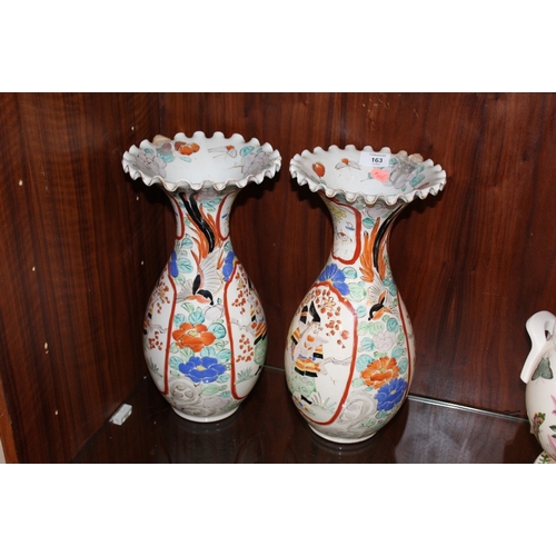 163 - A PAIR OF ORIENTAL BALUSTER VASES WITH FRILLED RIMS, each vase decorated with a figure in a shaped c... 