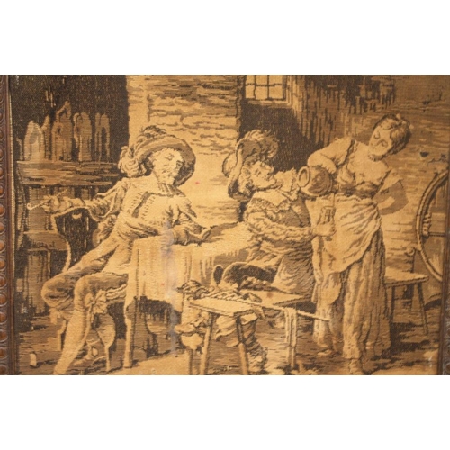 17 - AN ANTIQUE TAPESTRY/ NEEDLEWORK  PANEL DEPICTING AN INTERIOR SCENE WITH FIGURES IN OAK BARLEY TWIST ... 